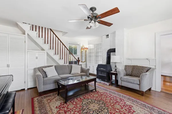 a living room with furniture and a ceiling fan