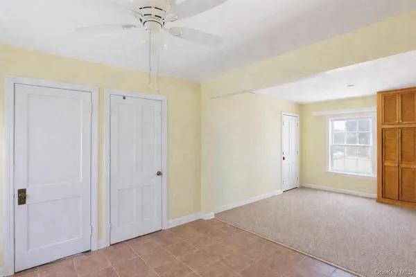a view of a room with window & entryway