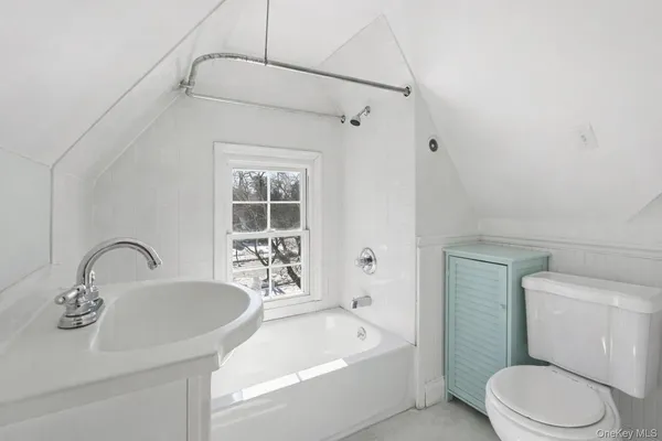 a bathroom with a sink a toilet and bathtub