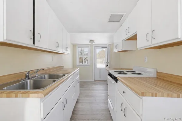 a kitchen that has a sink and a stove