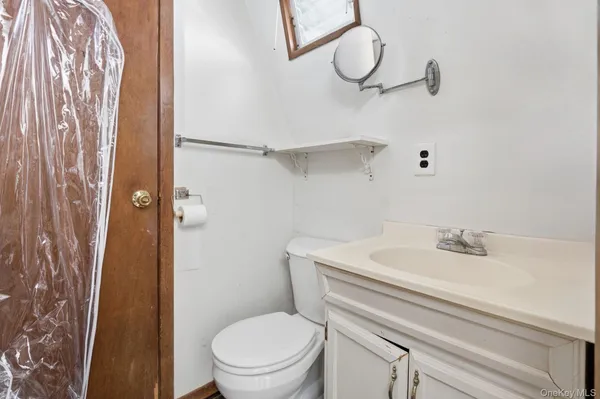 a bathroom with a sink a toilet and shower curtain