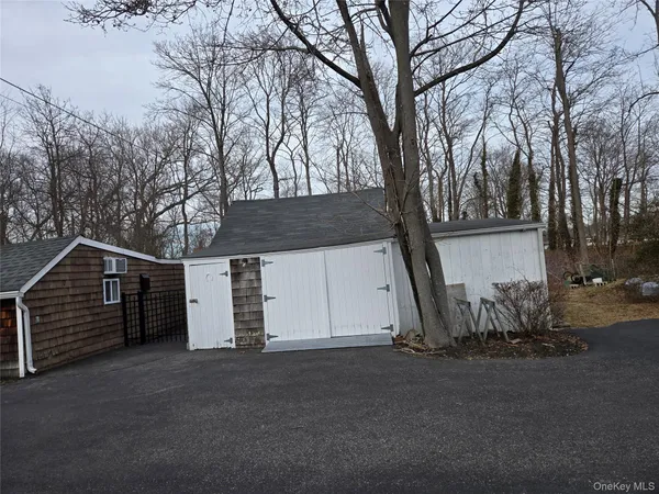 a view of garage and wooden fence