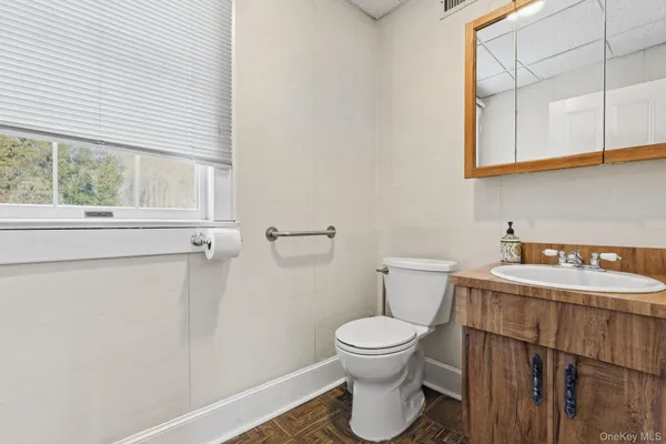 a white toilet sitting next to a bathroom sink