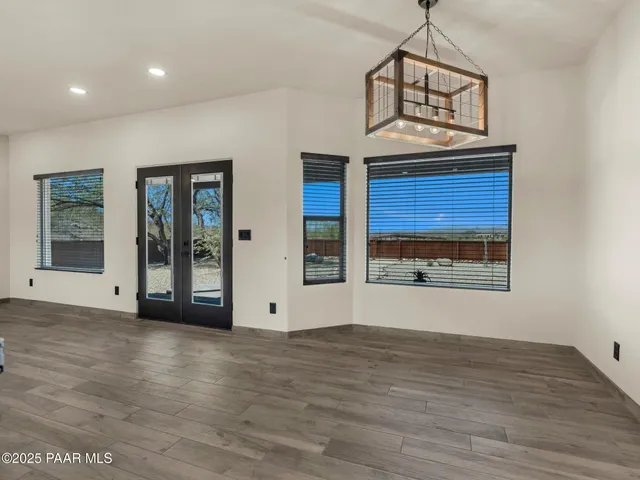 a view of a livingroom with wooden floor and window