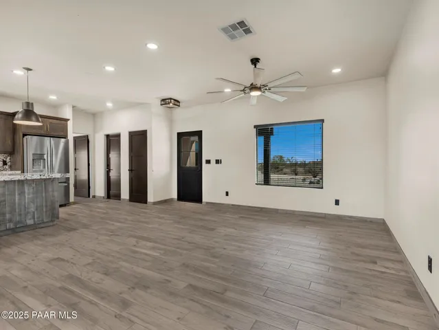 a kitchen with kitchen island a counter top space a sink stainless steel appliances and cabinets