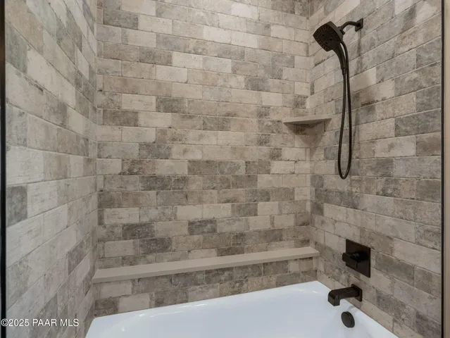 a view of a lake with a table and chairs in front of it