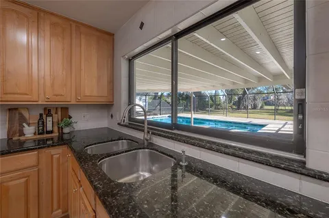 a kitchen with a sink and a large window