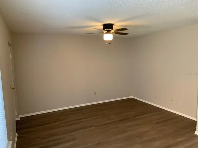 a view of a room with wooden floor and white walls