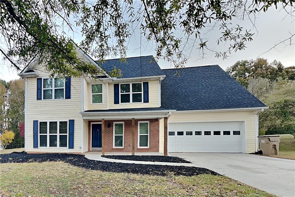 6072 Devonshire Drive Flowery Branch, GA 30542 - Photo 1 of 22 a front view of a house with a garden