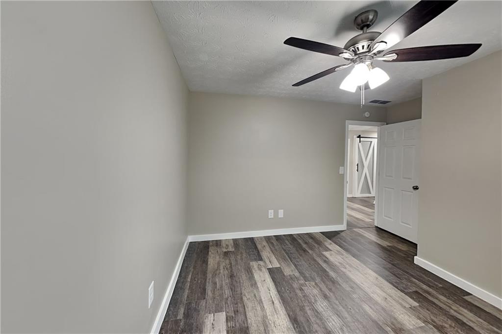 6072 Devonshire Drive Flowery Branch, GA 30542 - Photo 13 of 22 wooden floor in an empty room