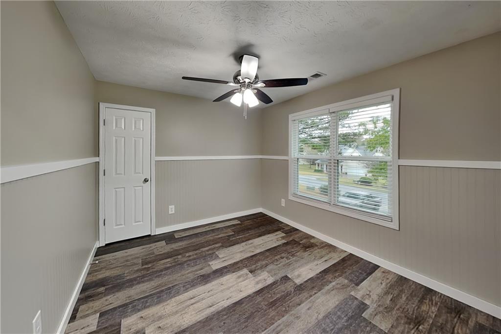 6072 Devonshire Drive Flowery Branch, GA 30542 - Photo 15 of 22 wooden floor in an empty room with a window