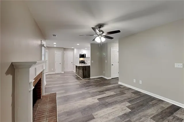 a view of an empty room with a fireplace