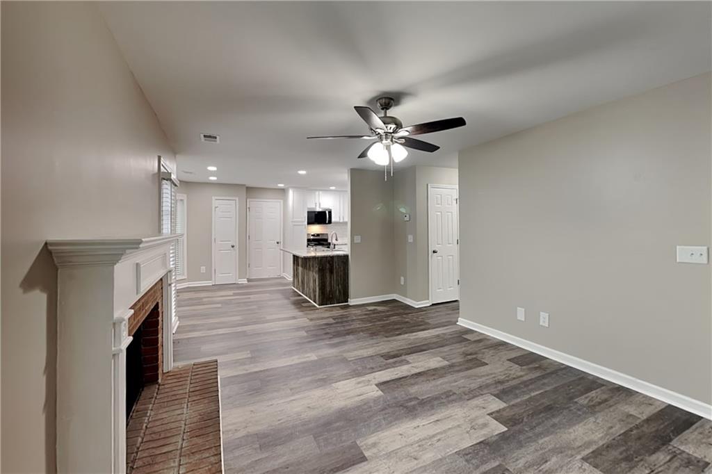 6072 Devonshire Drive Flowery Branch, GA 30542 - Photo 5 of 22 a view of an empty room with a fireplace