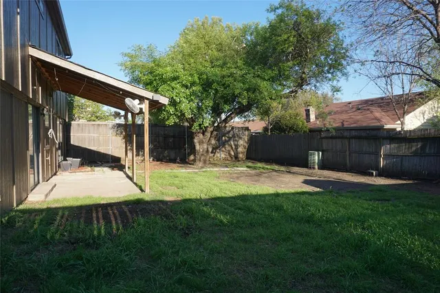 a view of a backyard with tree