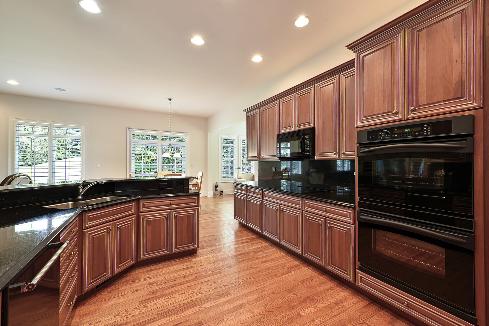 1002 Ridgeview Drive Inverness, IL 60010 - Photo 10 of 34 a kitchen with stainless steel appliances granite countertop wooden cabinets a sink a stove a refrigerator and dishwasher with wooden floor