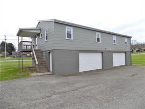 107 Adelaide Road, Unit A Connellsville, PA 15425 - Photo 1 of 8 a front view of a house with a yard