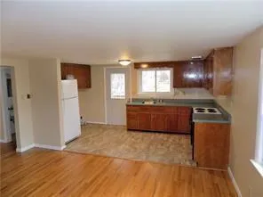 a kitchen with granite countertop a stove and a refrigerator