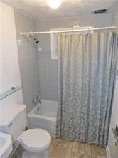 a white toilet sitting next to a bathroom sink