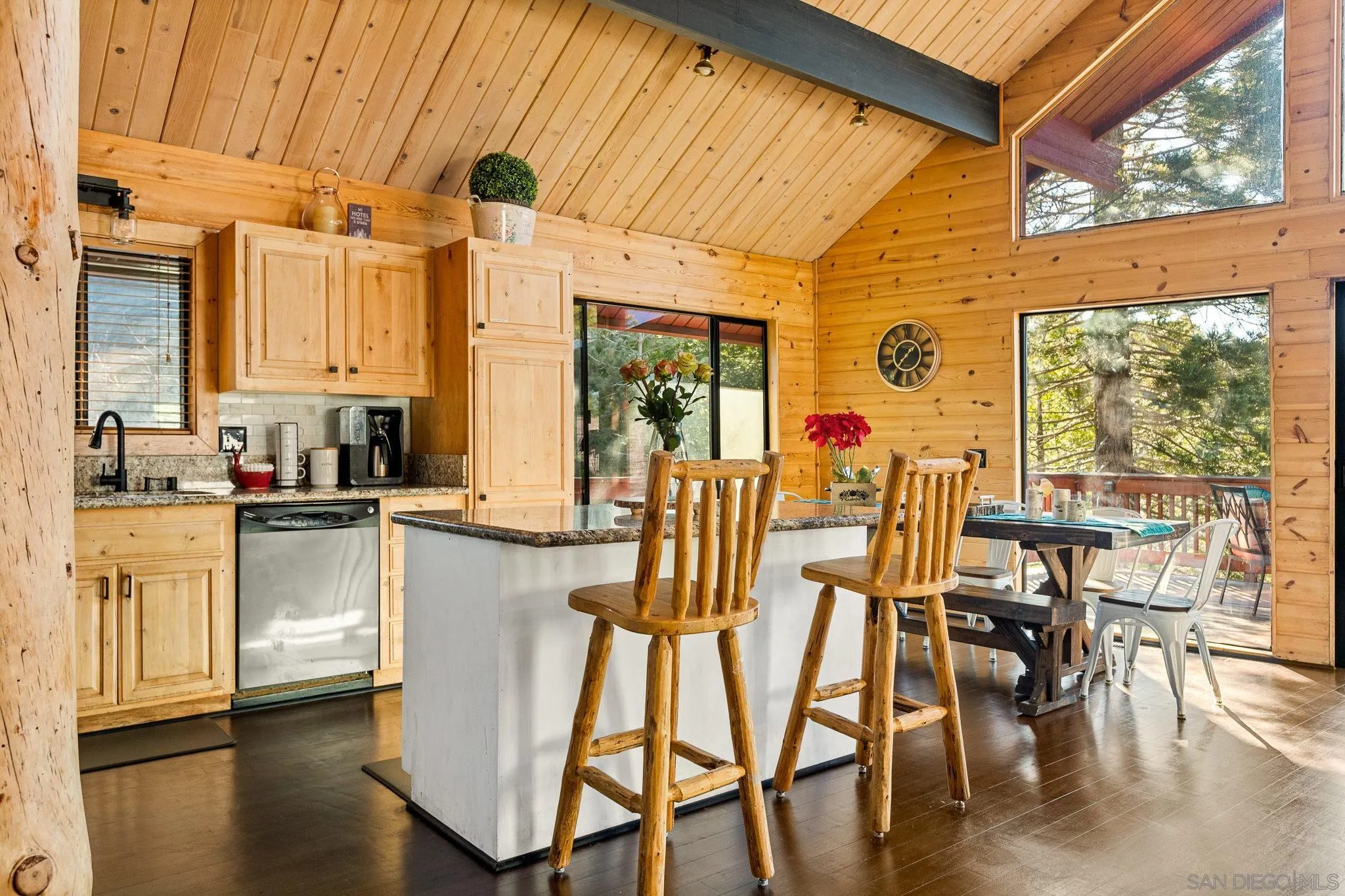 683 Grass Valley Road Lake Arrowhead, CA 92352 - Photo 12 of 39 a kitchen with stainless steel appliances granite countertop a table chairs and a large window
