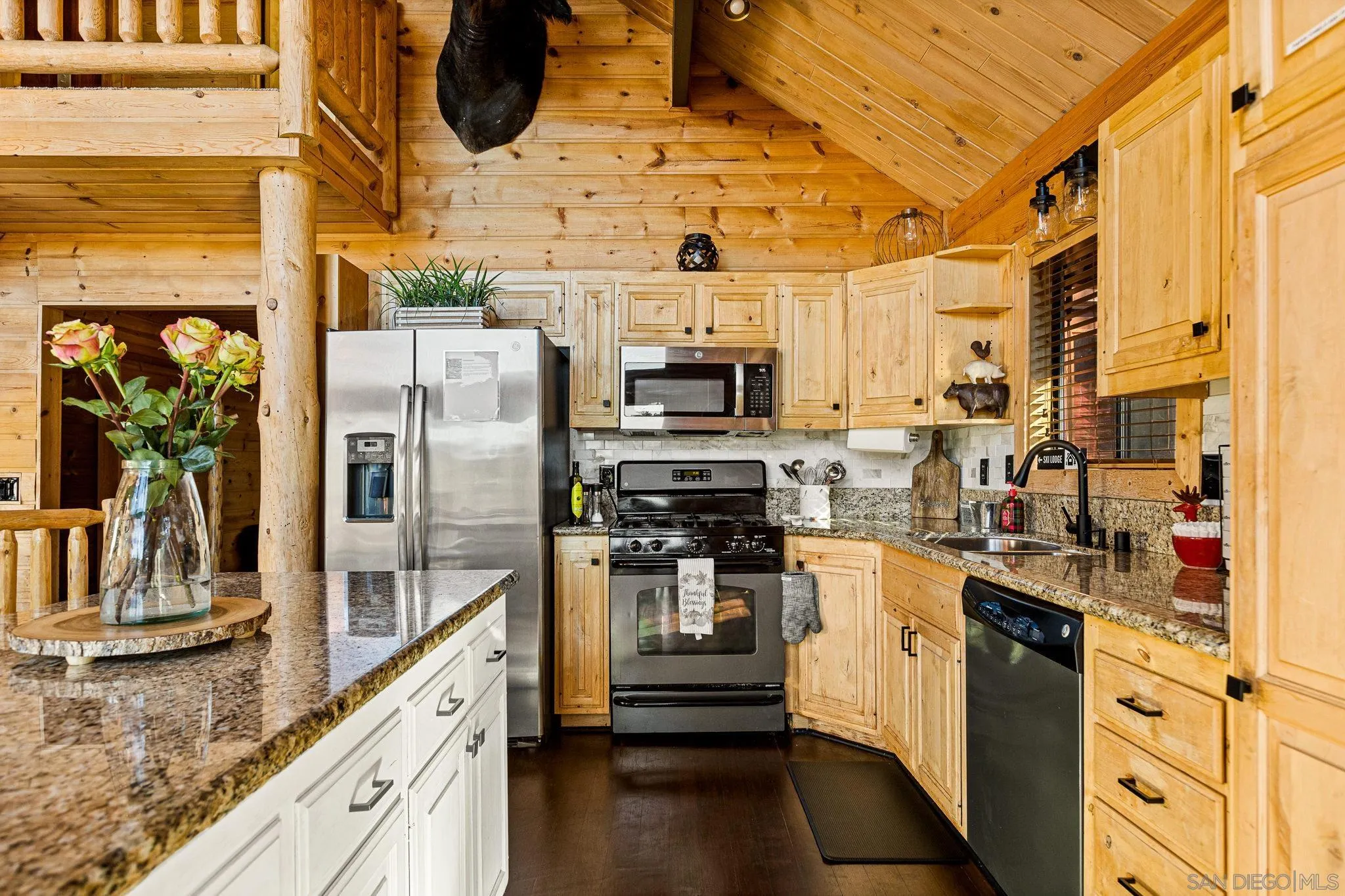 683 Grass Valley Road Lake Arrowhead, CA 92352 - Photo 14 of 39 a kitchen with stainless steel appliances granite countertop a refrigerator a stove and a sink with wooden floor