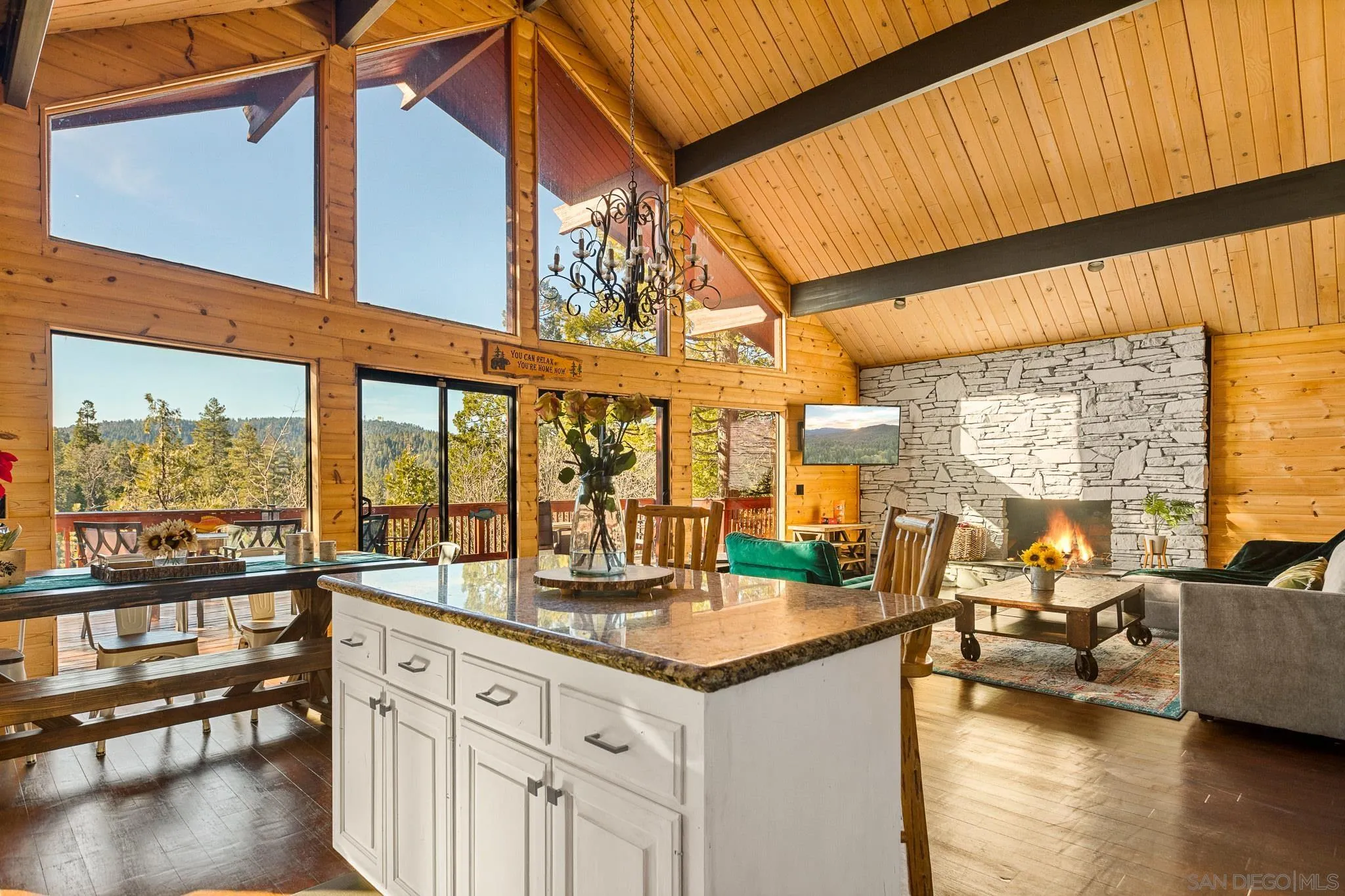 683 Grass Valley Road Lake Arrowhead, CA 92352 - Photo 16 of 39 a view of a living room and kitchen with a large window