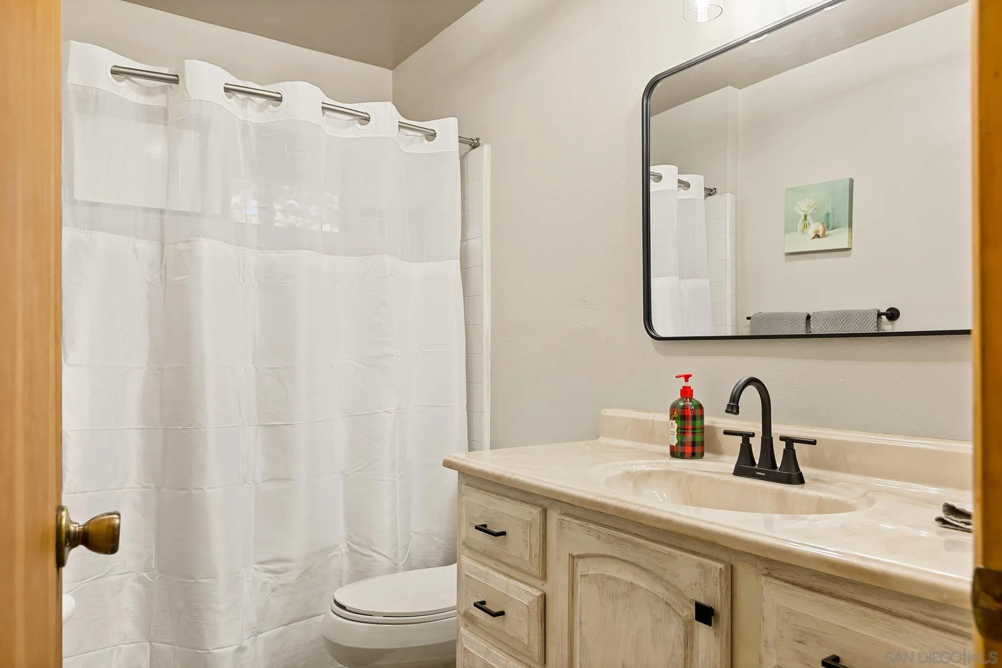 683 Grass Valley Road Lake Arrowhead, CA 92352 - Photo 20 of 39 a bathroom with a sink a toilet and a mirror