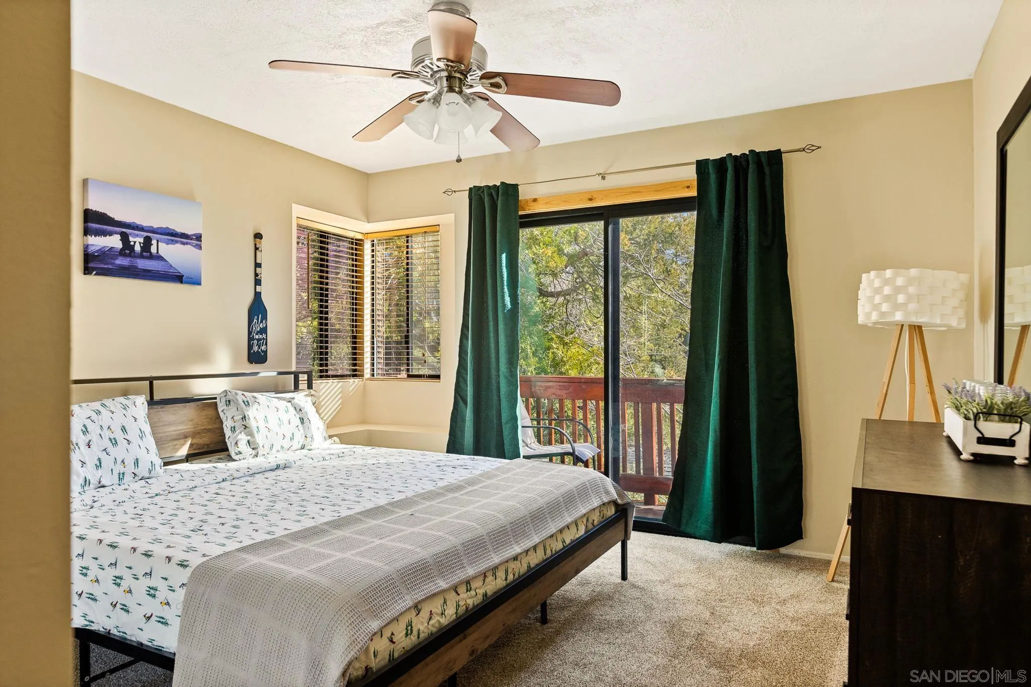 683 Grass Valley Road Lake Arrowhead, CA 92352 - Photo 24 of 39 a bedroom with a large bed and a chandelier