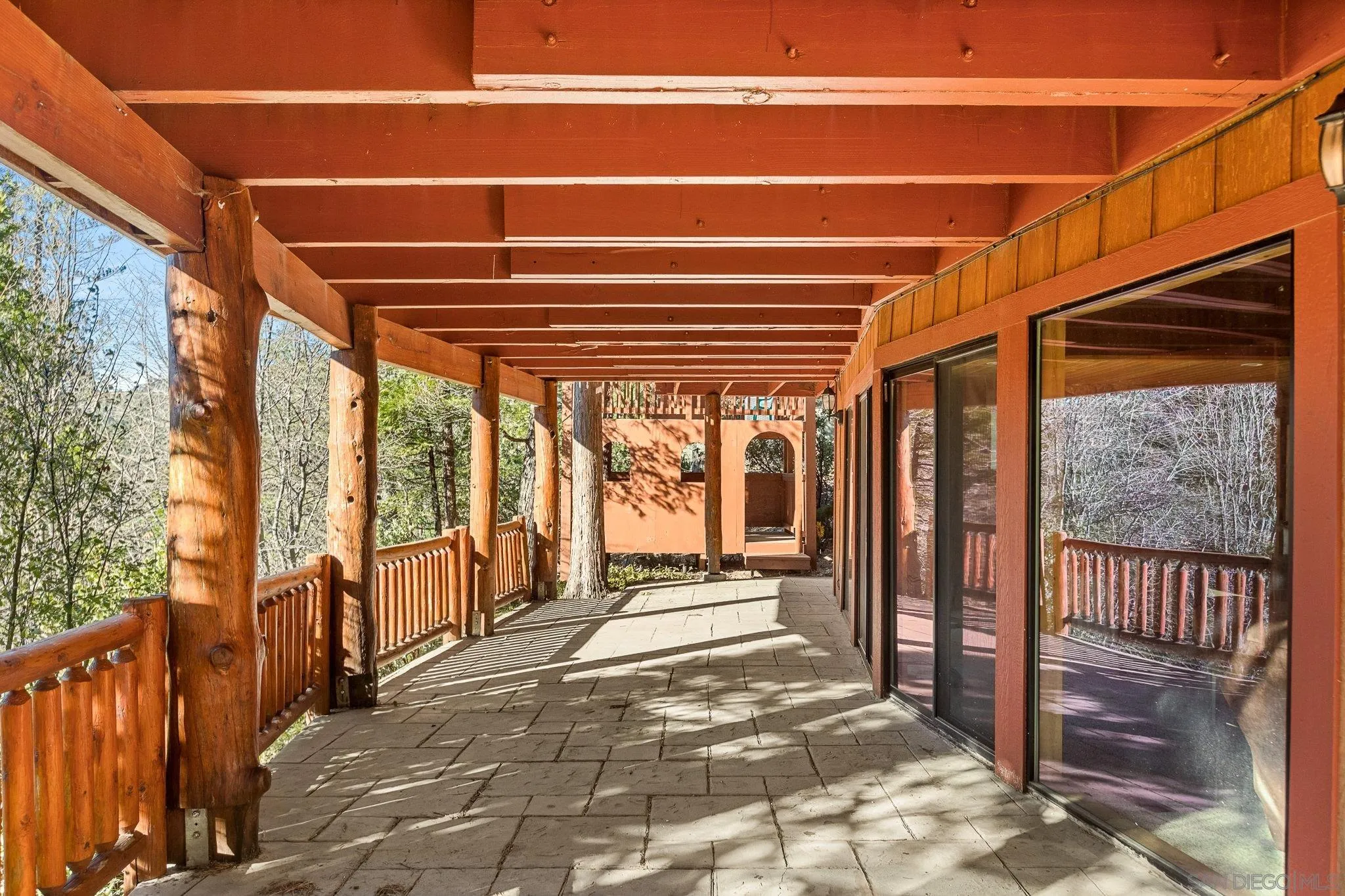 683 Grass Valley Road Lake Arrowhead, CA 92352 - Photo 36 of 39 a view of a porch with wooden floor and iron stairs