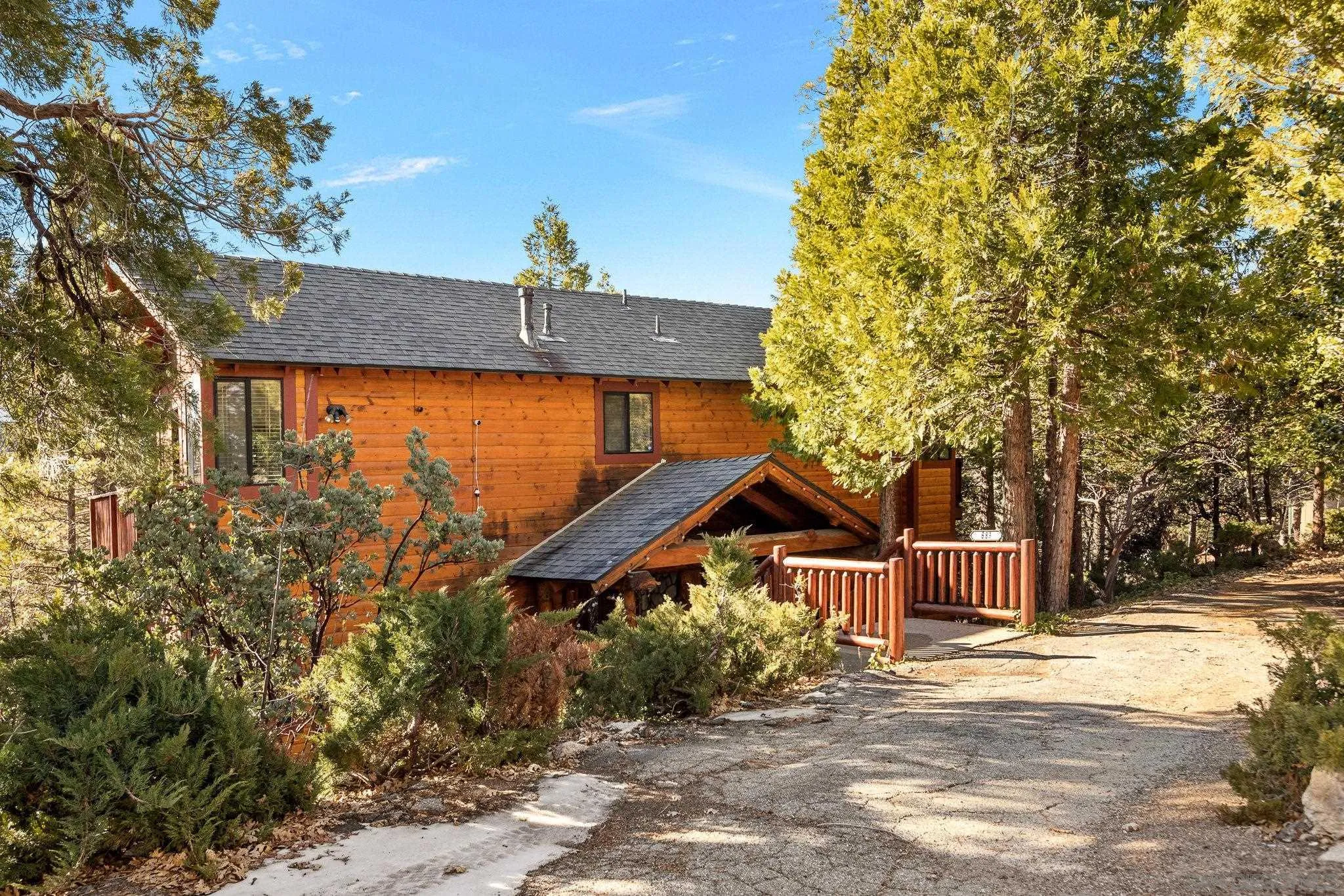683 Grass Valley Road Lake Arrowhead, CA 92352 - Photo 7 of 39 a front view of a house with a yard