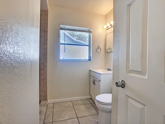 a white toilet sitting next to a bathroom sink