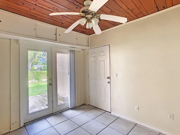 a view of a livingroom with a ceiling fan and window