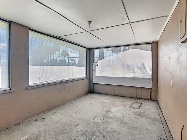 a view of an empty room with a window