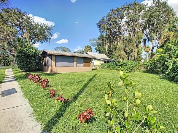 a front view of house with yard and trees