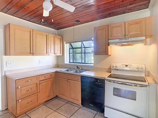 a kitchen with a stove sink and cabinets