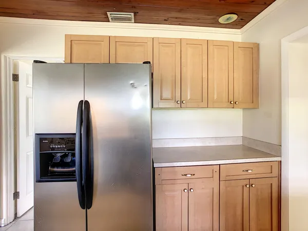 a kitchen with a refrigerator and cabinets