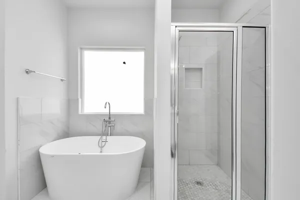 a white bath tub sitting next to a bathroom sink