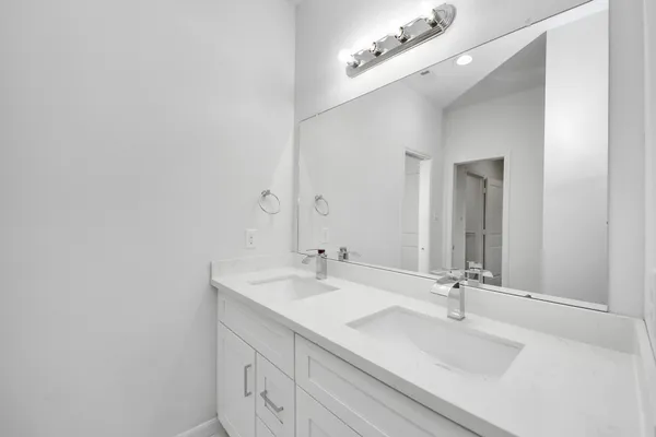 a bathroom with a double vanity sink a mirror and vanity