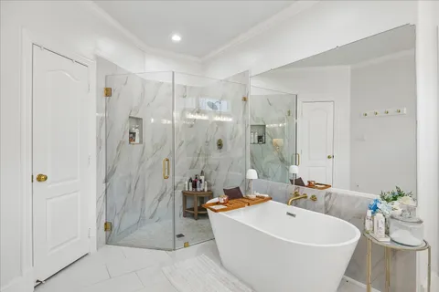 a view of a bathroom with a tub shower and mirror