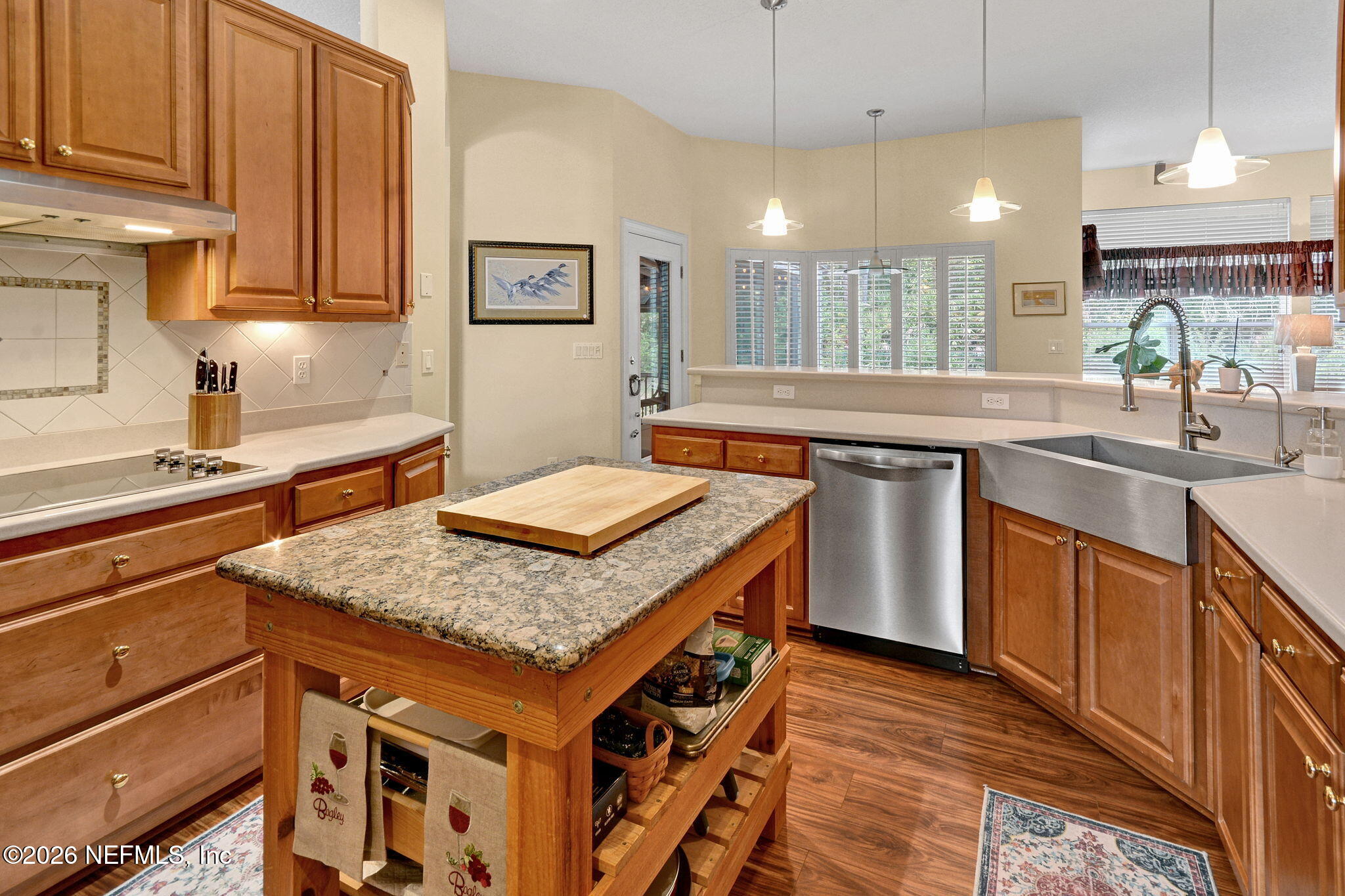 5950 West Shores Road Orange Park, FL 32003 - Photo 14 of 42 a kitchen with a stove window and cabinets