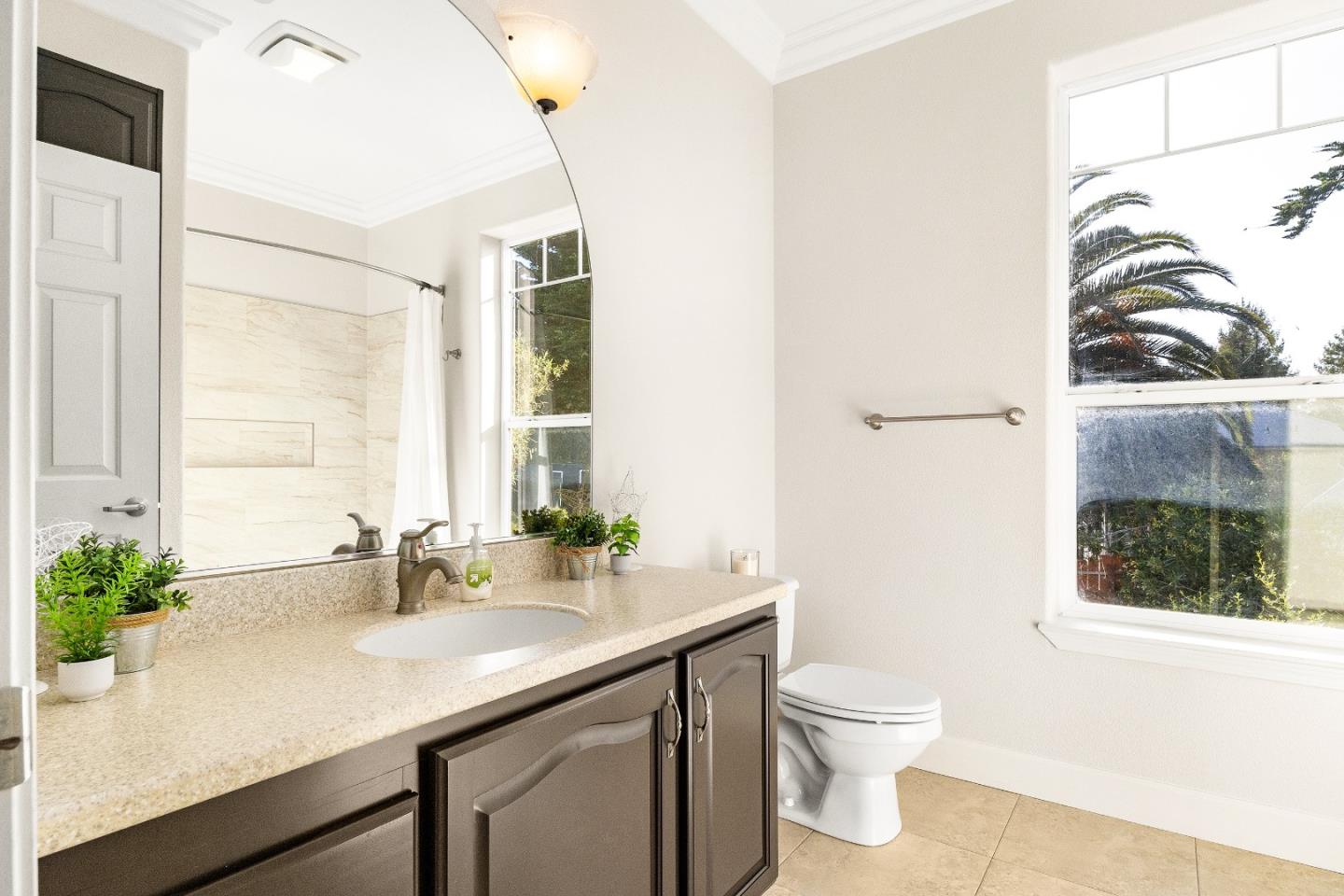 960 Smith Road Watsonville, CA 95076 - Photo 35 of 53 a bathroom with a granite countertop sink a toilet and mirror