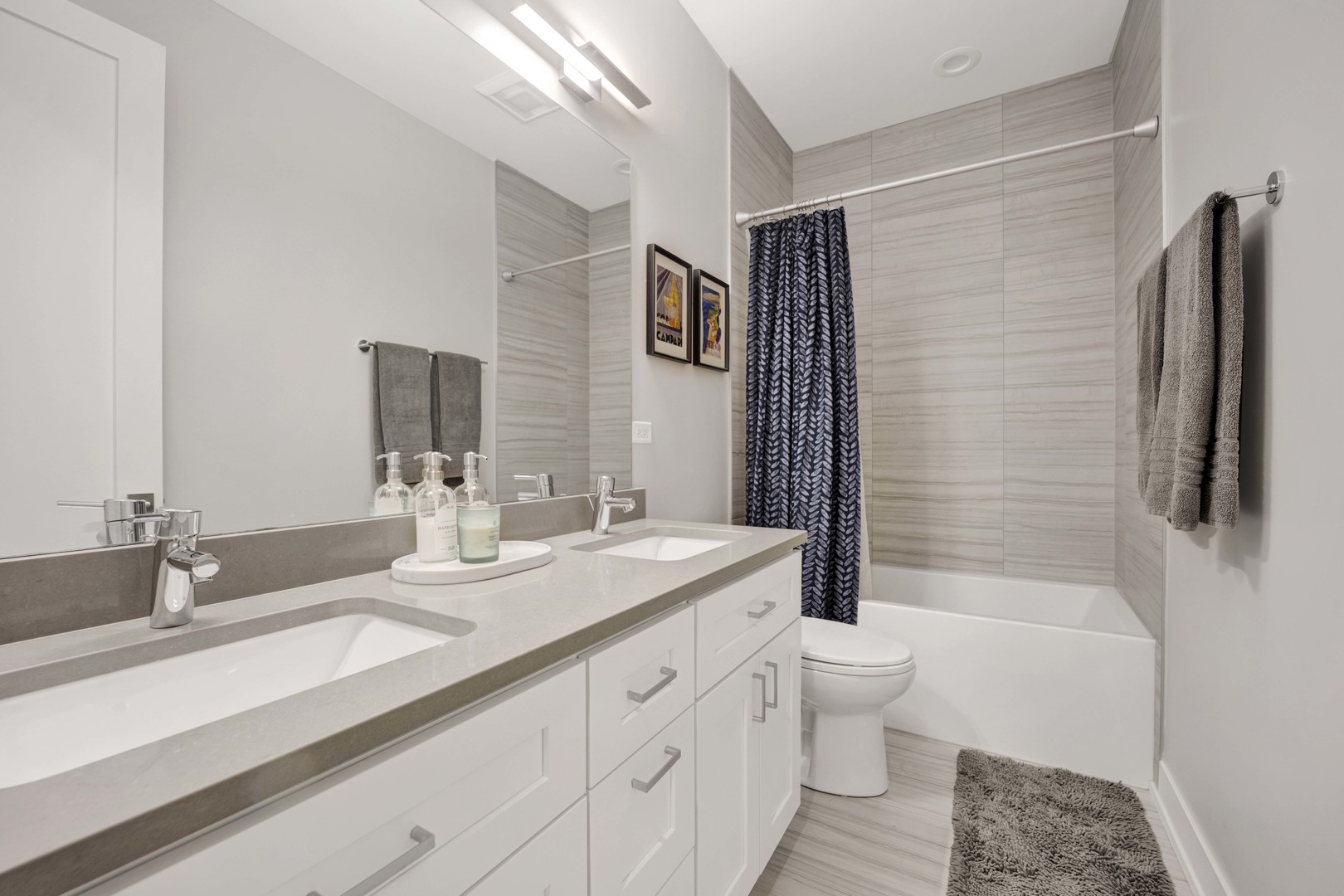 2140 West Rice Street, Unit 1W Chicago, IL 60622 - Photo 16 of 25 a bathroom with a double vanity sink toilet and shower
