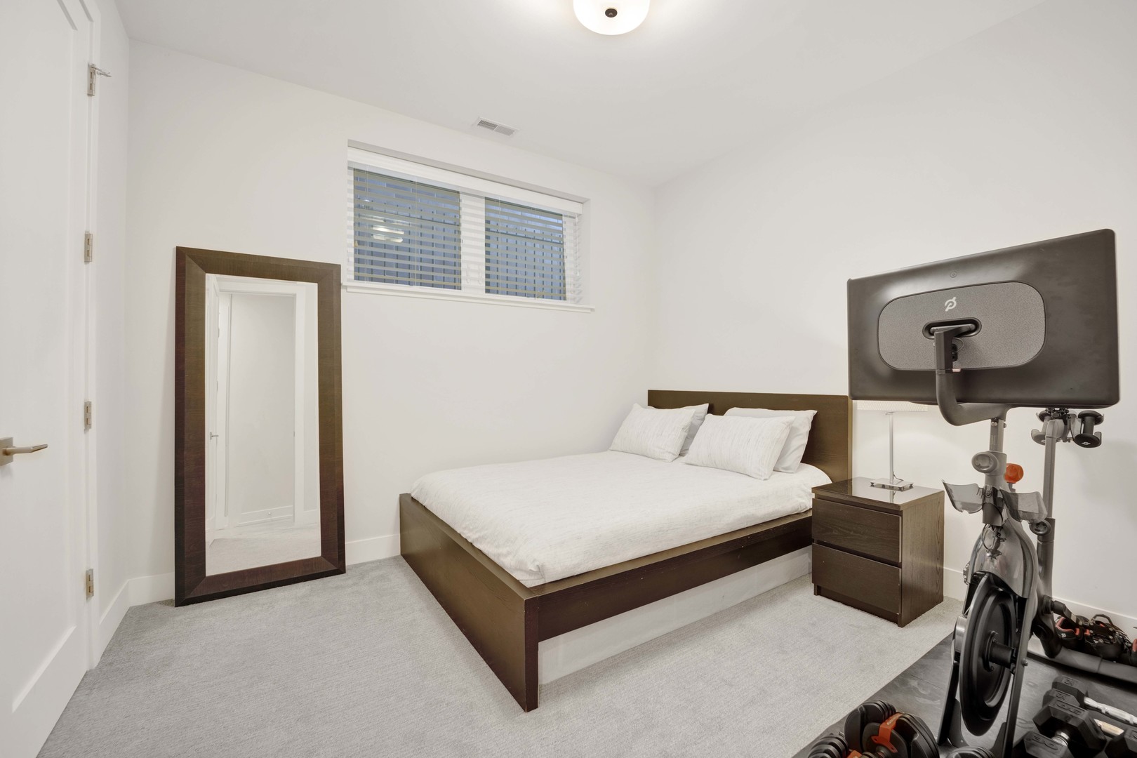 2140 West Rice Street, Unit 1W Chicago, IL 60622 - Photo 17 of 25 a bedroom with a bed and dresser with mirror