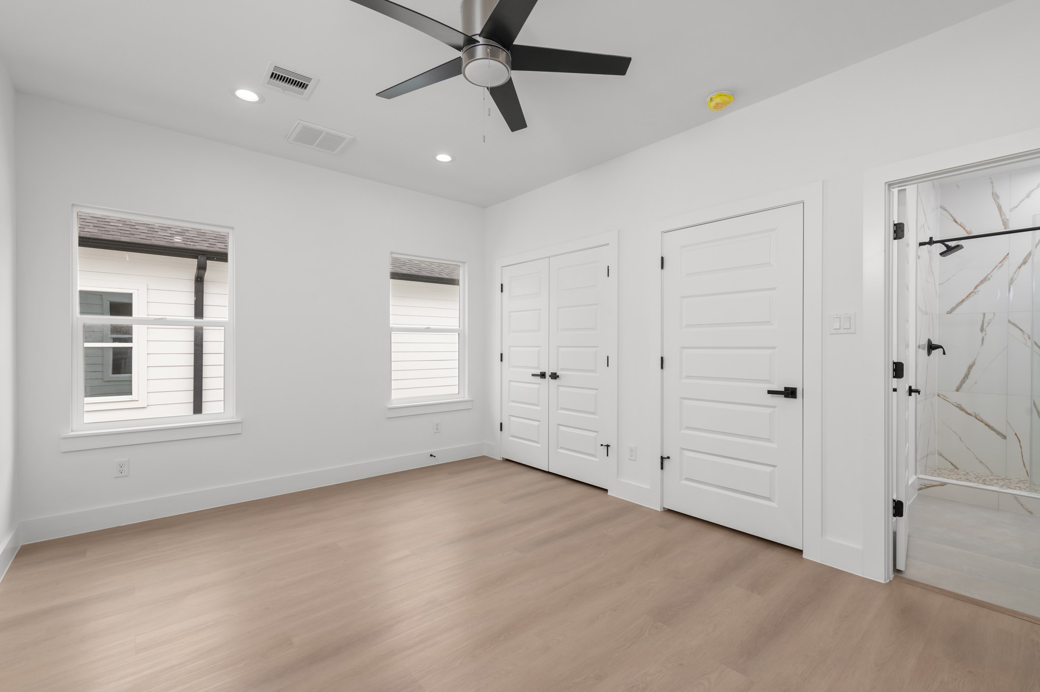 2316 McKee Street, Unit A Houston, TX 77009 - Photo 12 of 12 an empty room with windows and fan