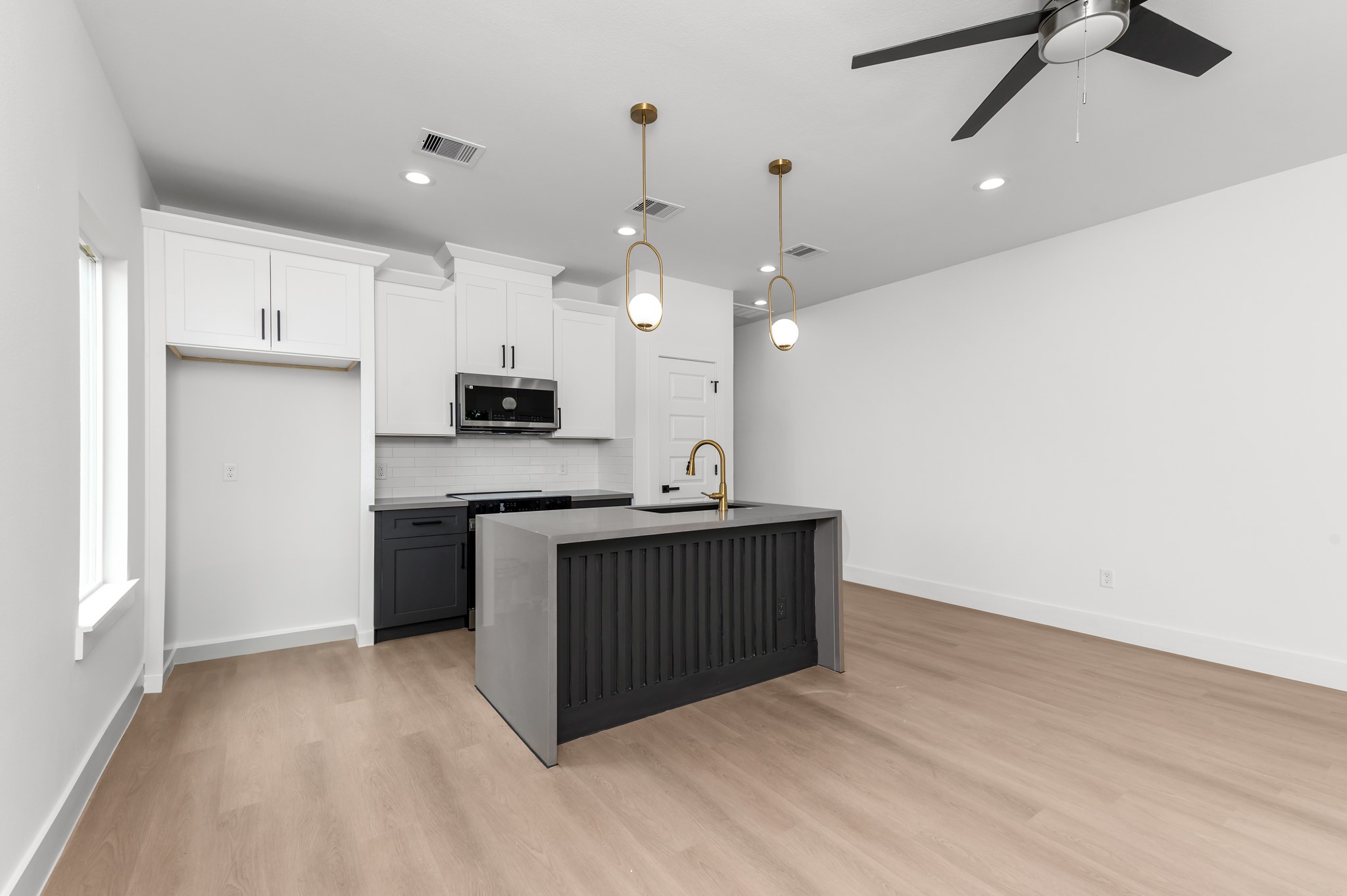 2316 McKee Street, Unit A Houston, TX 77009 - Photo 3 of 12 an open kitchen with a sink and microwave
