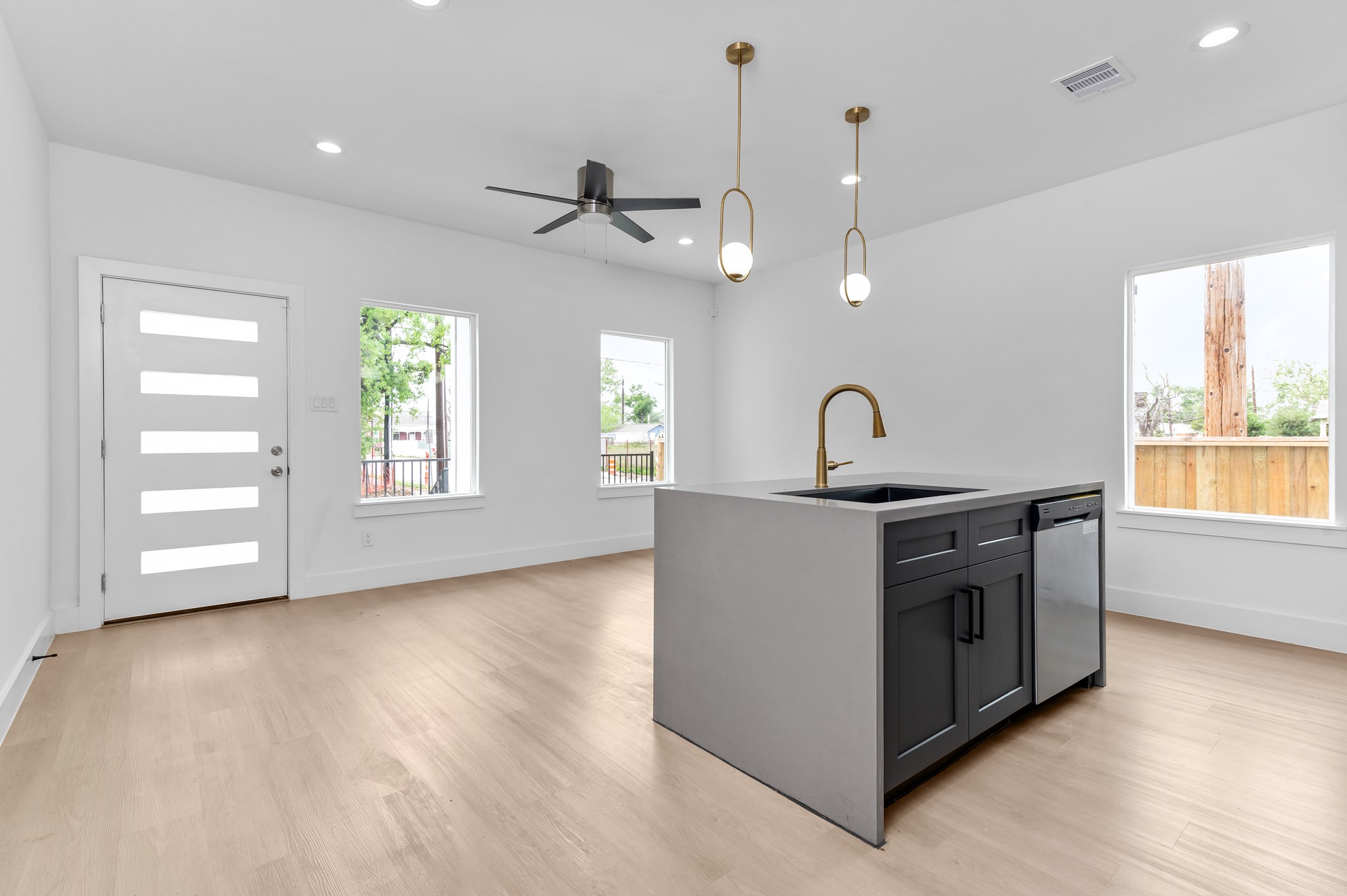 2316 McKee Street, Unit A Houston, TX 77009 - Photo 5 of 12 a kitchen with stainless steel appliances granite countertop a sink a stove a window and a hard wood floor