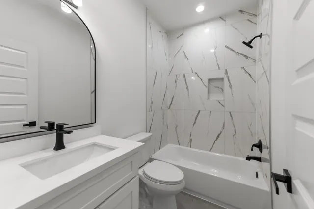 a bathroom with a sink a toilet and a bathtub