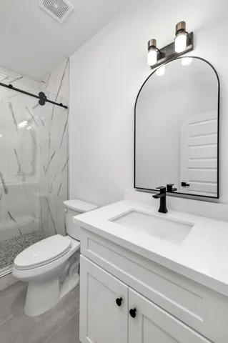 a bathroom with a sink toilet and a mirror