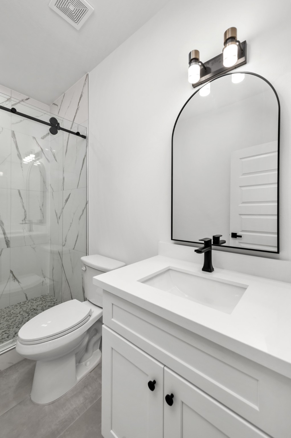2316 McKee Street, Unit A Houston, TX 77009 - Photo 10 of 12 a bathroom with a sink toilet and a mirror