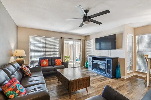 a view of a dining room with furniture wooden floor and a fireplace