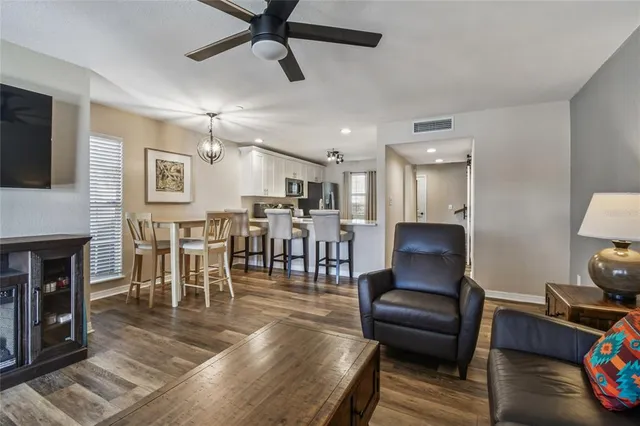 a bedroom with a bed a large window and a flat screen tv